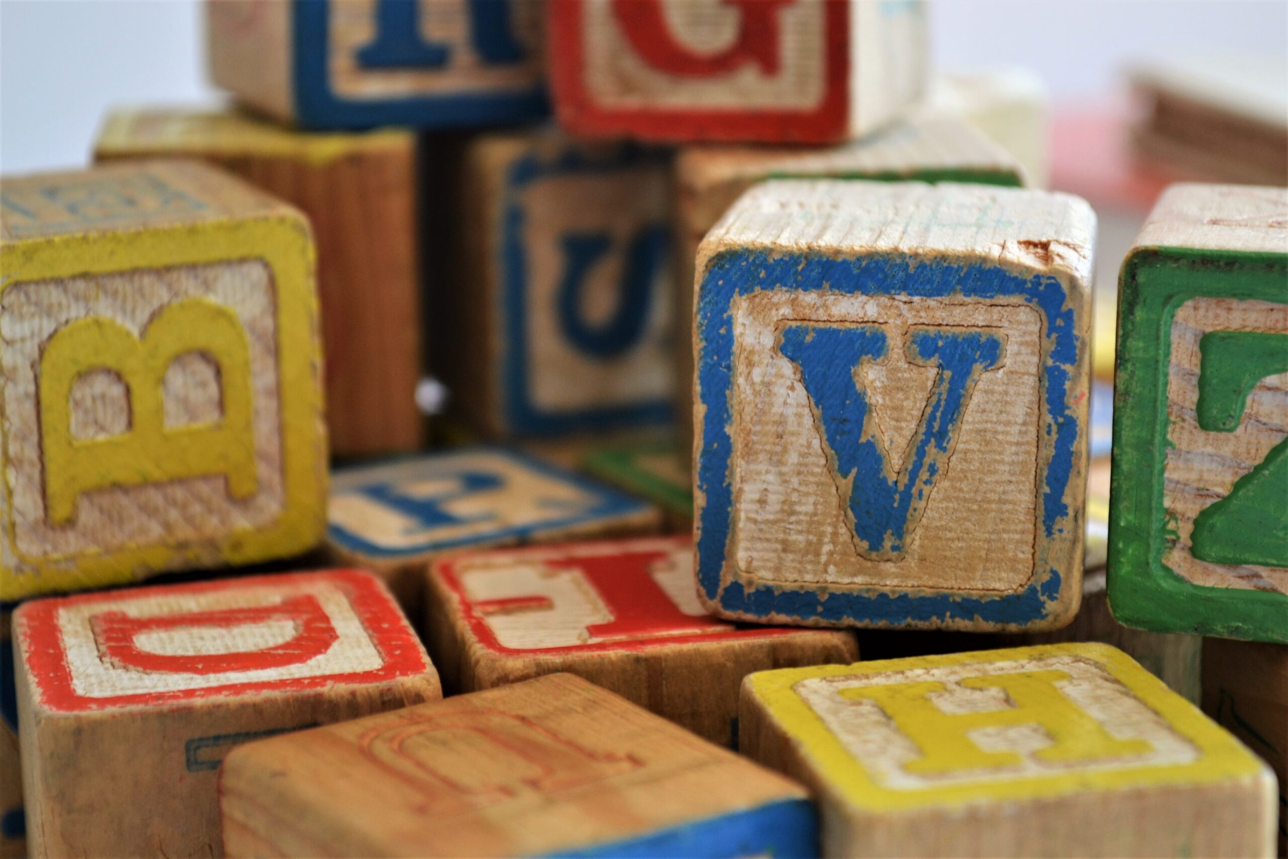 Colorful wooden children's blocks with letters of the alphabet.