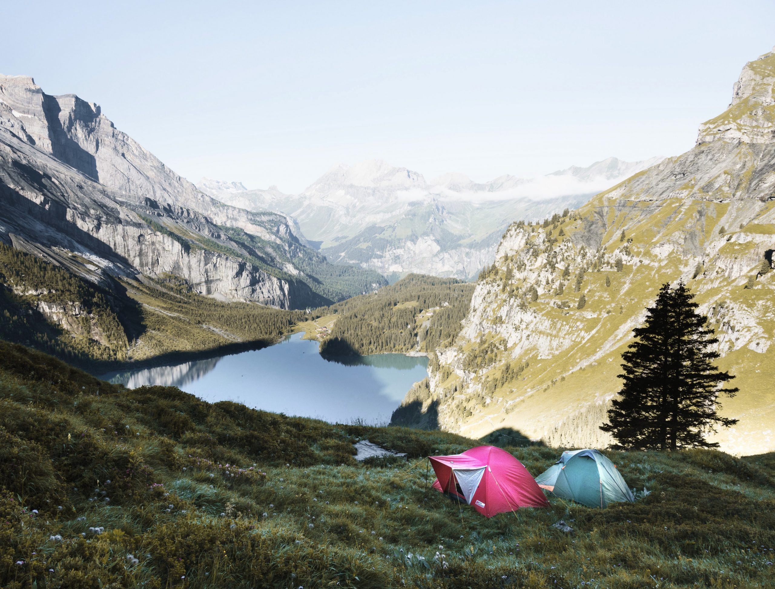 Tents in front of lake and mountains