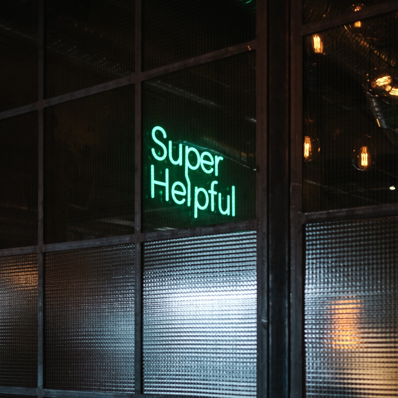 Neon sign reading "Super Helpful"