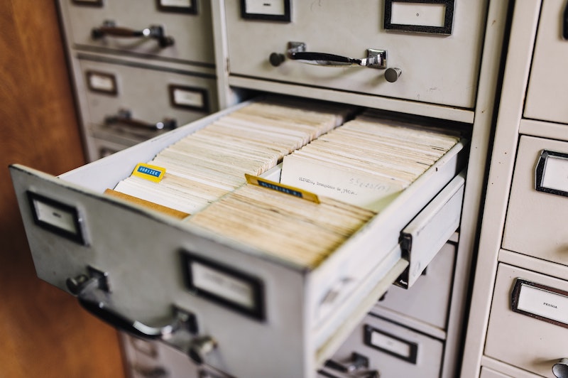 File drawer opened to reveal neatly organized, off white files.