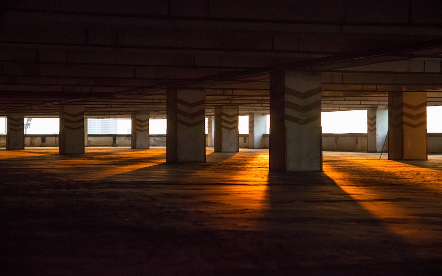 Concrete building foundation with sunlight streaming through pillars