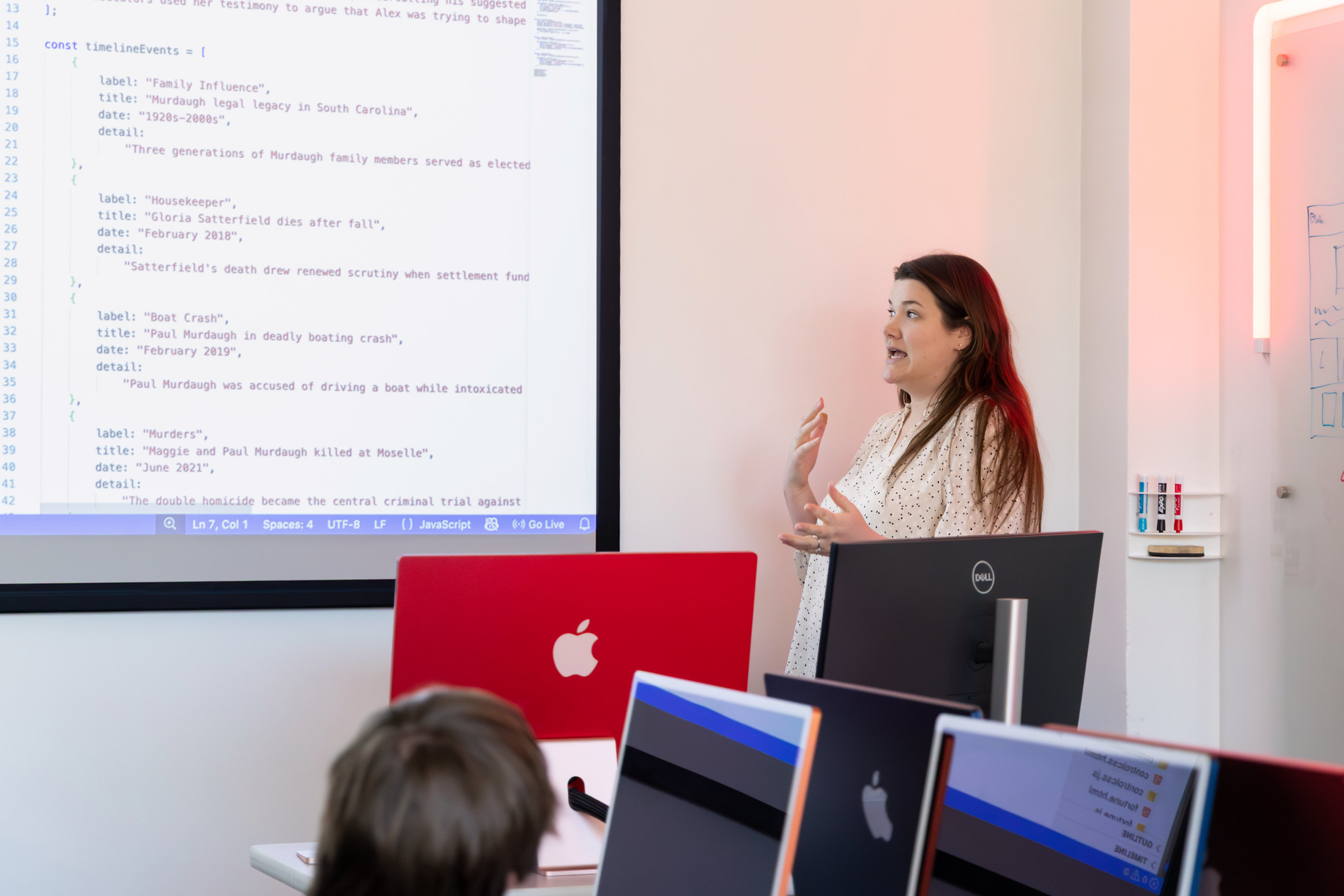 Claire Jordan teaching a class with code on the projector